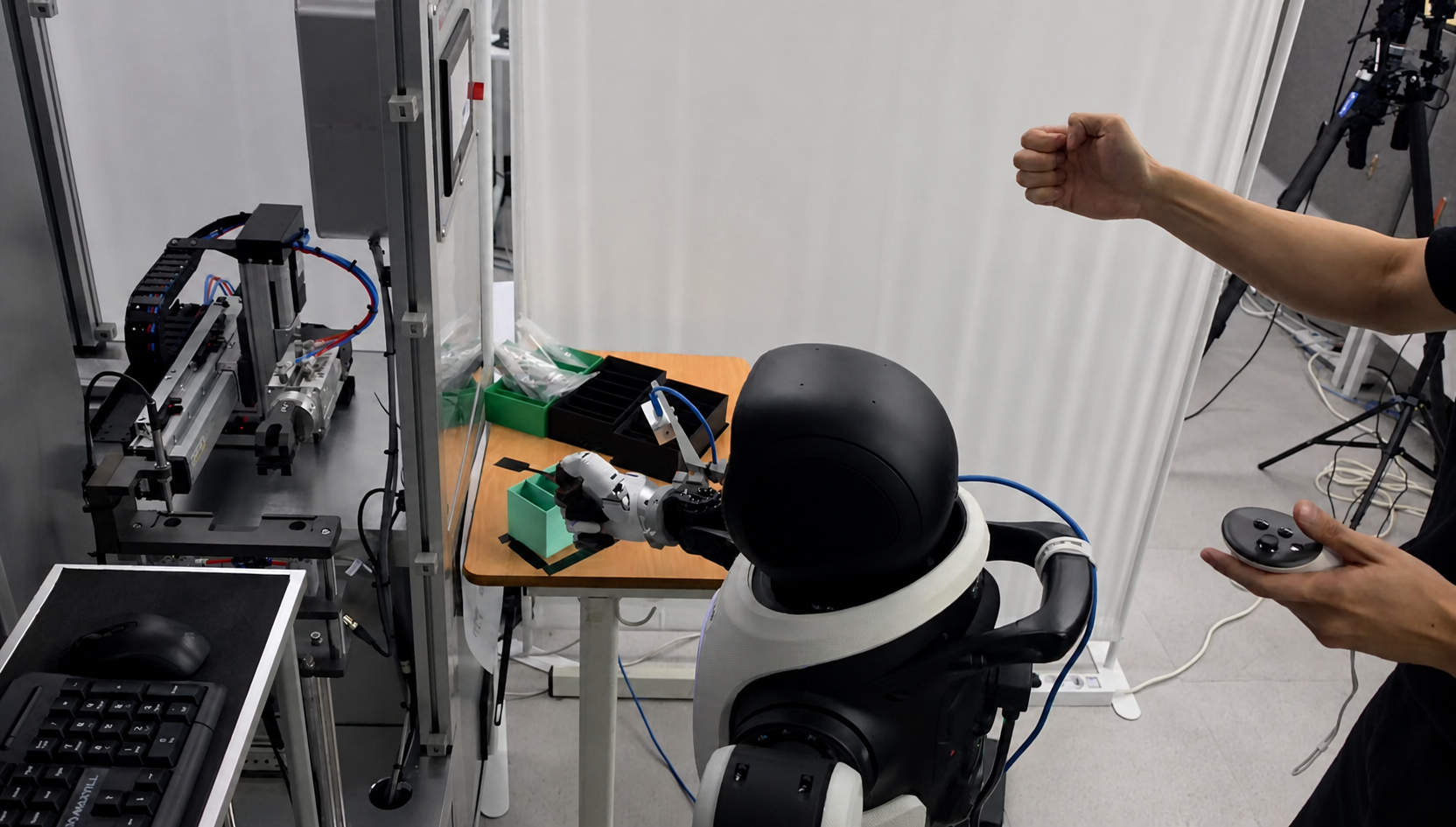 Agibot humanoid robot operating beside a tensile-testing apparatus through VR teleoperation